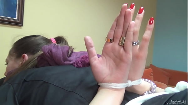 dame tied up in restrain bondage with palms out