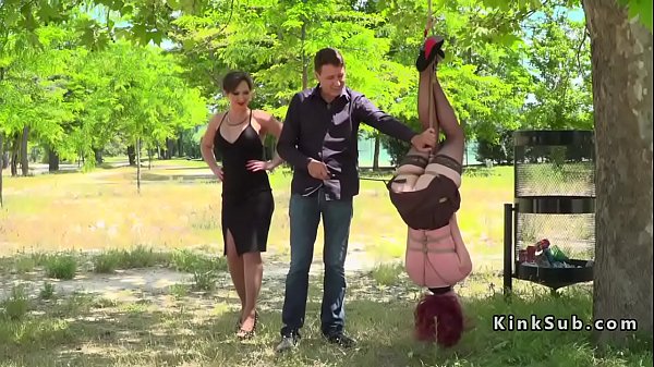 Ginger-haired in stockings suspended in park
