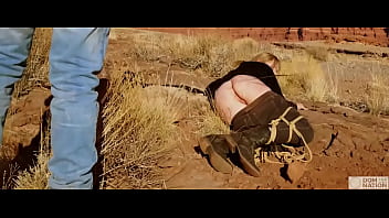 Subjugated honey gets an asshole whipping before getting butt fucked on pee-covered ground — a hard, genuine dominance venture out in nature (Rebel Rhyder)